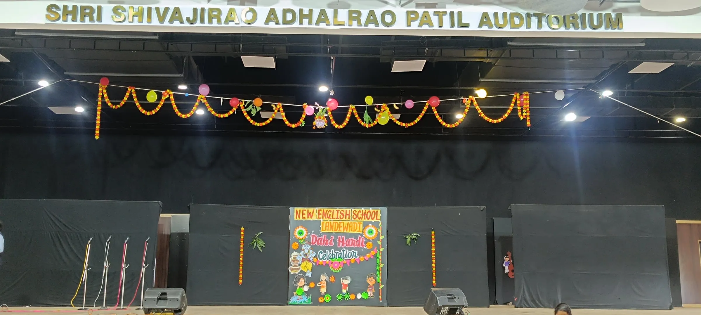 The auditorium stage decorated with marigold garlands