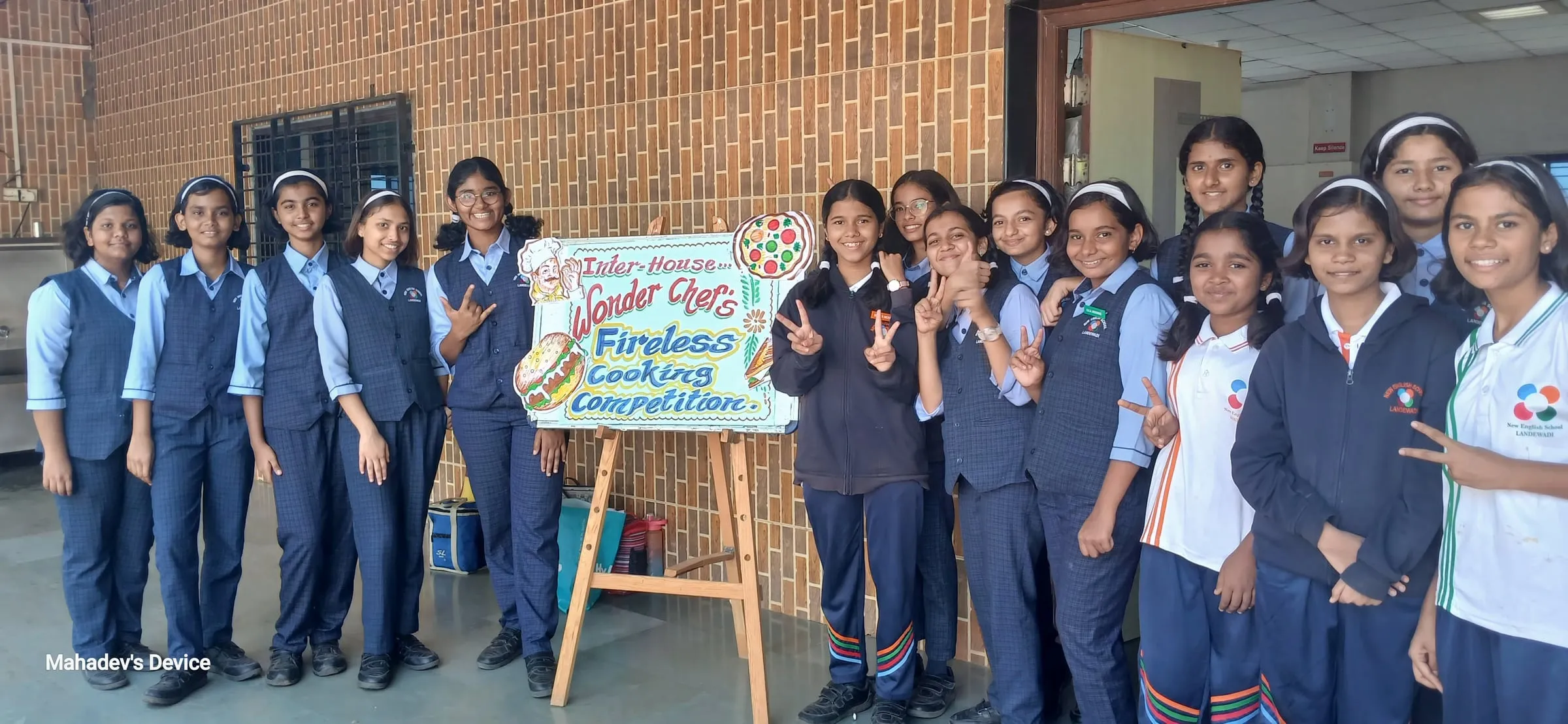 Students in blazers beside a Wonder Chefs fireless cooking banner