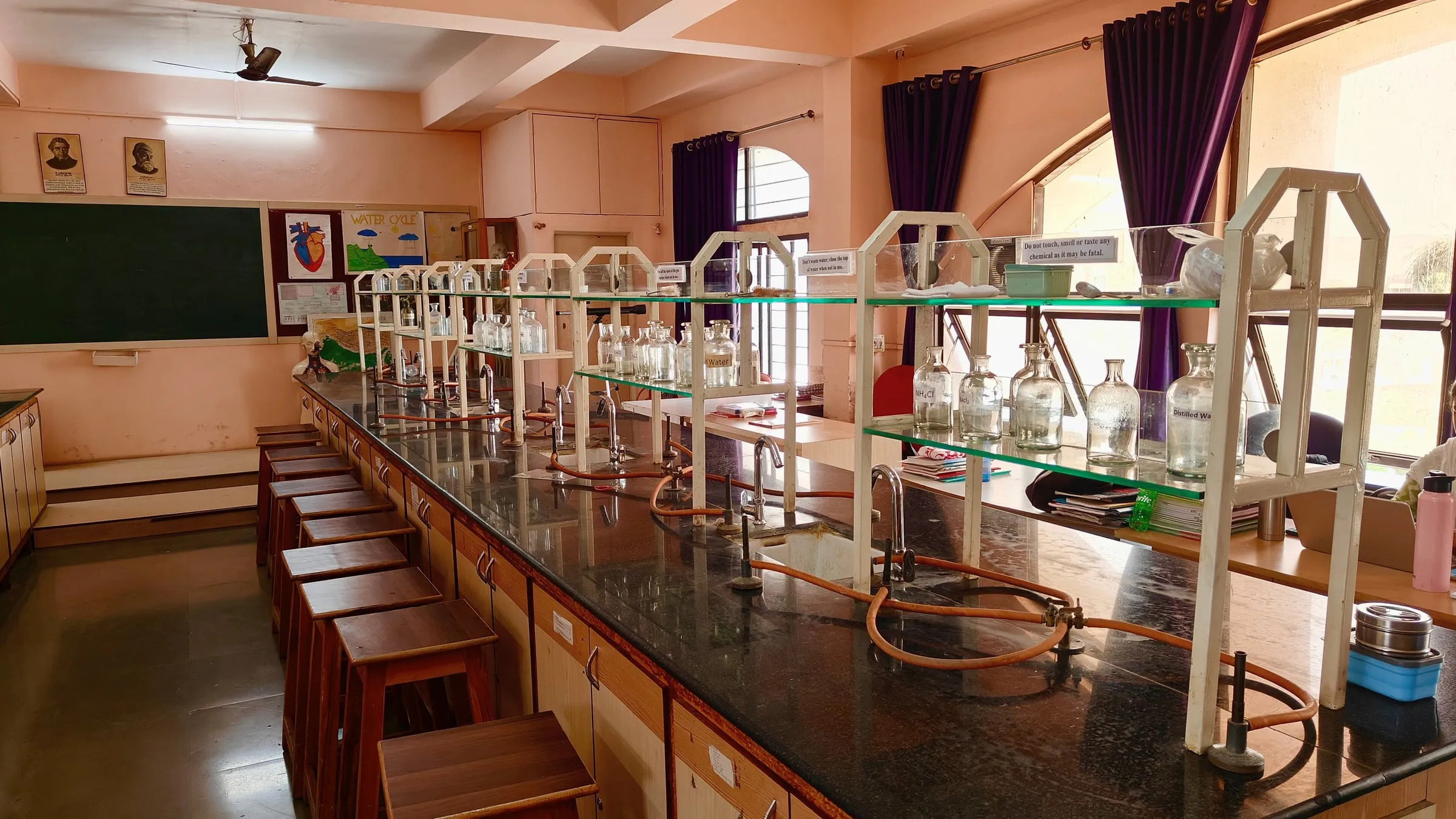 A science lab with long benches and glass reagent racks