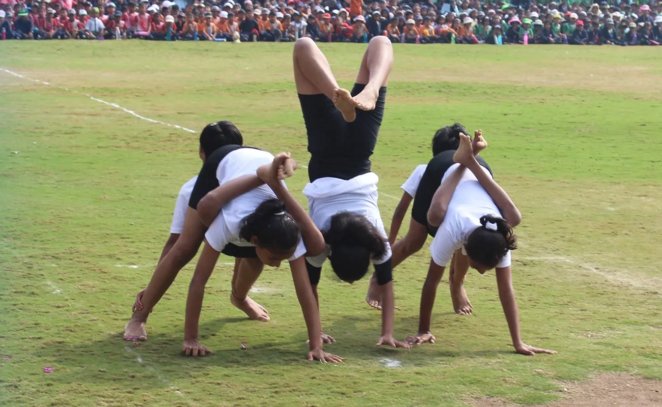 Students doing yoga on the grass